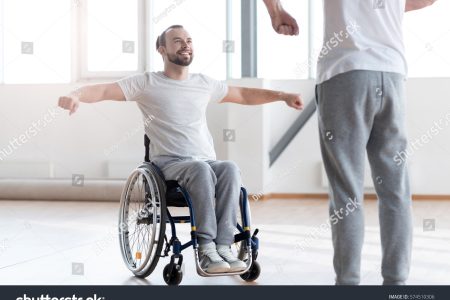 stock-photo-attentive-disabled-man-training-in-the-gym-with-the-orthopedist-574510306